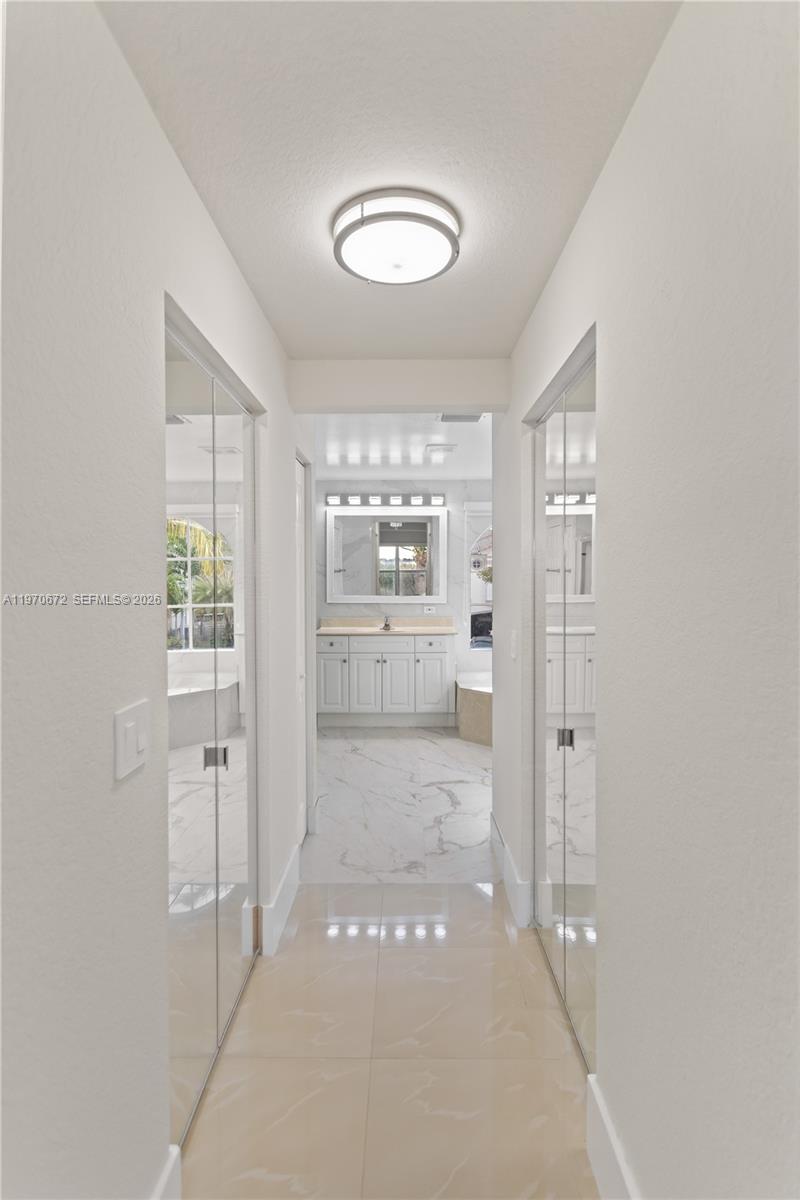 4116 Southwest 179th Way Miramar, FL 33029 - Photo 18 of 43 a bathroom with a glass door shower