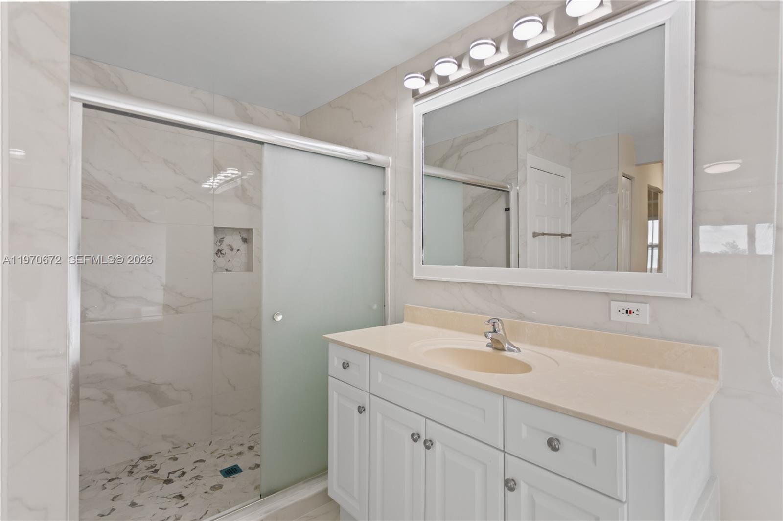 4116 Southwest 179th Way Miramar, FL 33029 - Photo 21 of 43 a bathroom with a sink a light fixture and a mirror