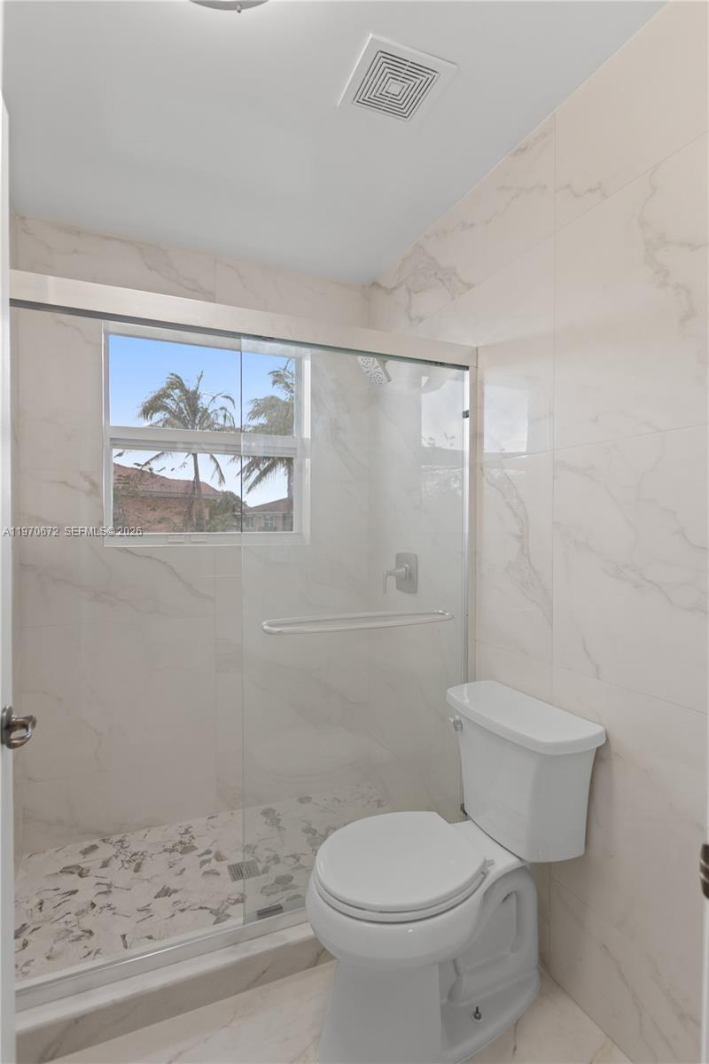 4116 Southwest 179th Way Miramar, FL 33029 - Photo 28 of 43 a white toilet sitting next to a bathroom sink
