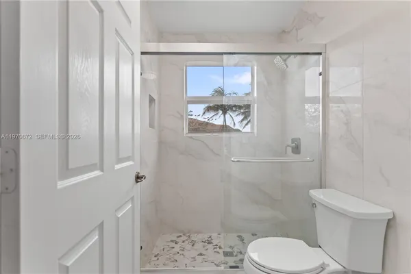 a white toilet sitting next to a bathroom sink