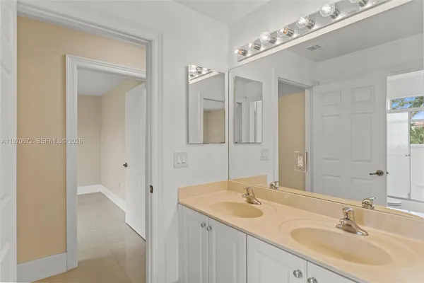 a bathroom with a sink double vanity and a mirror