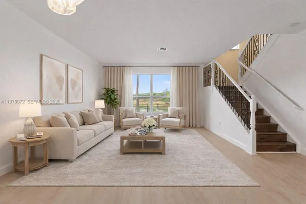 a living room with furniture and a large window