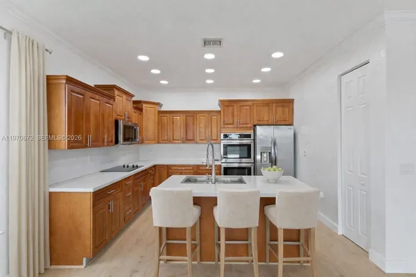 a kitchen with kitchen island granite countertop a sink and counter space
