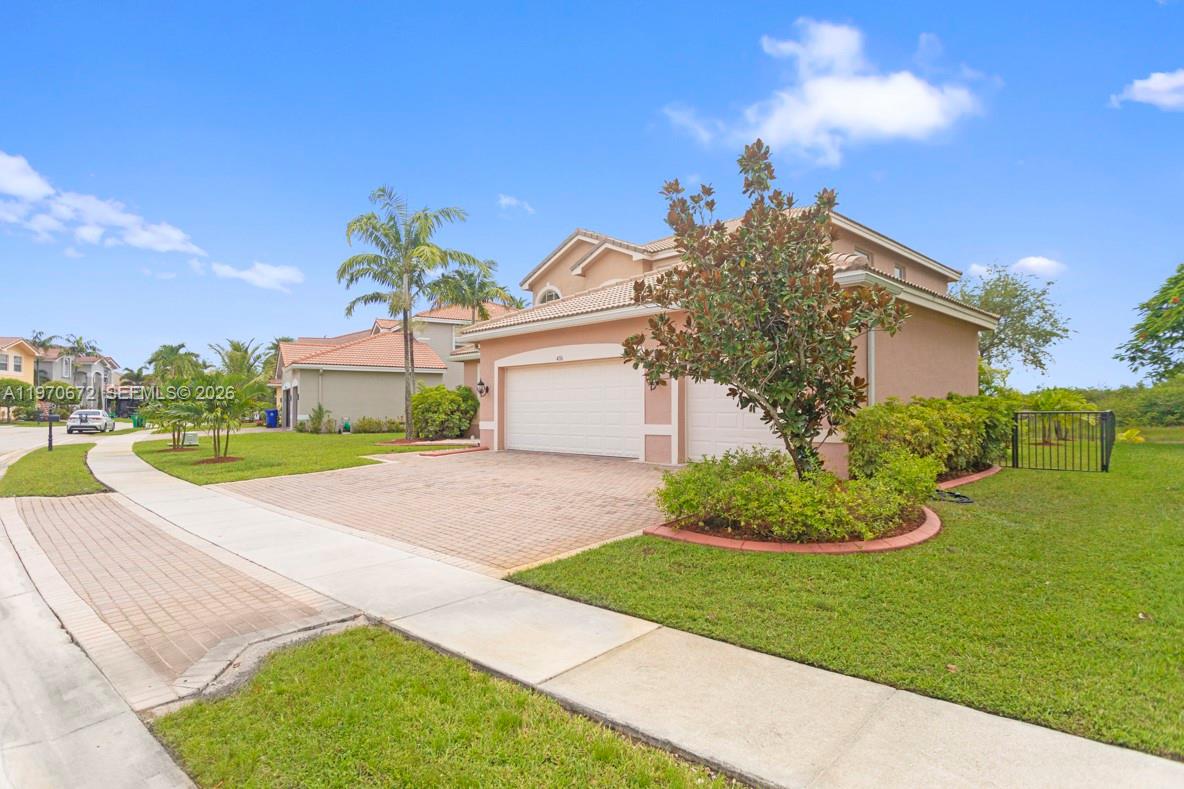 4116 Southwest 179th Way Miramar, FL 33029 - Photo 41 of 43 a view of a white house with a yard and potted plants