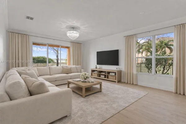 a living room with furniture and a flat screen tv