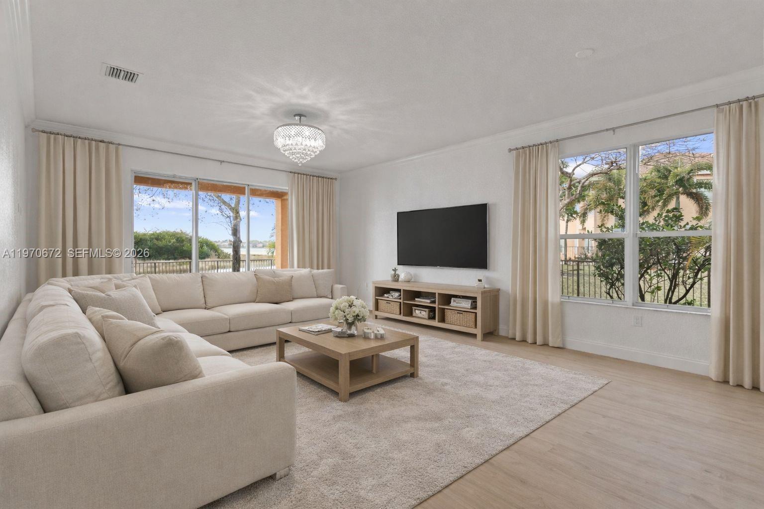 4116 Southwest 179th Way Miramar, FL 33029 - Photo 5 of 43 a living room with furniture and a flat screen tv