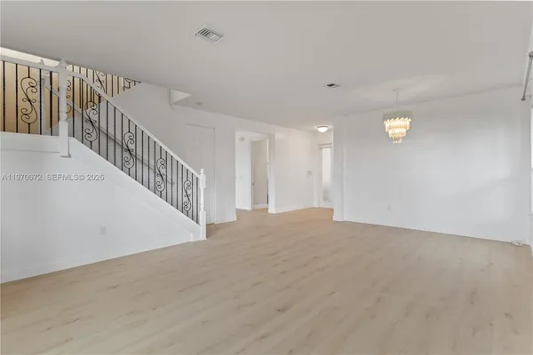 a view of an empty room with stairs