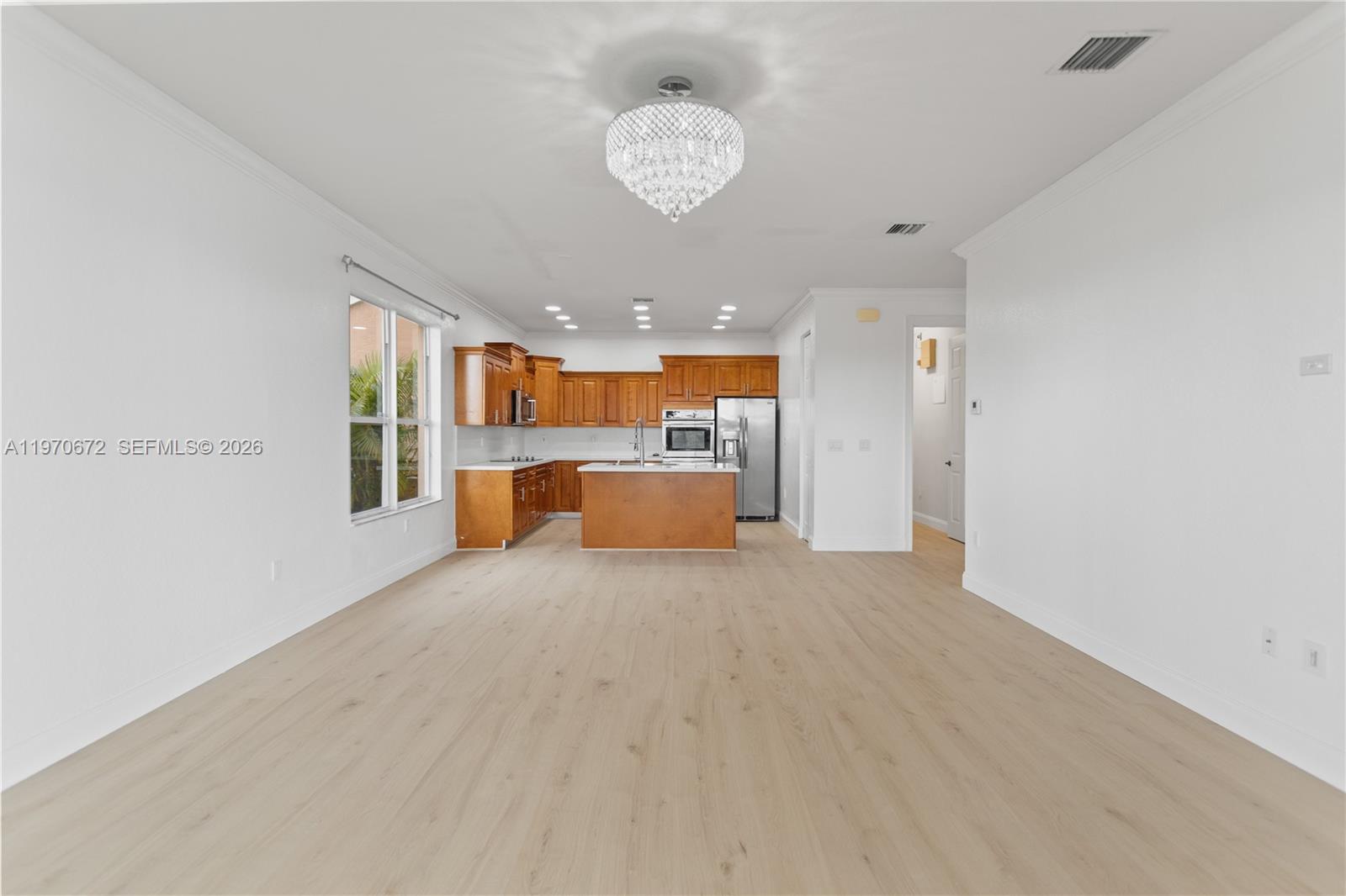 4116 Southwest 179th Way Miramar, FL 33029 - Photo 10 of 43 a big room with chandelier kitchen view and a window
