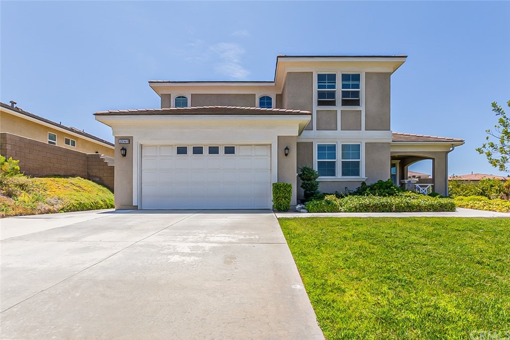 18069 Homeland Lane Riverside, CA 92508 - Photo 1 of 1 a front view of a house with a yard and garage