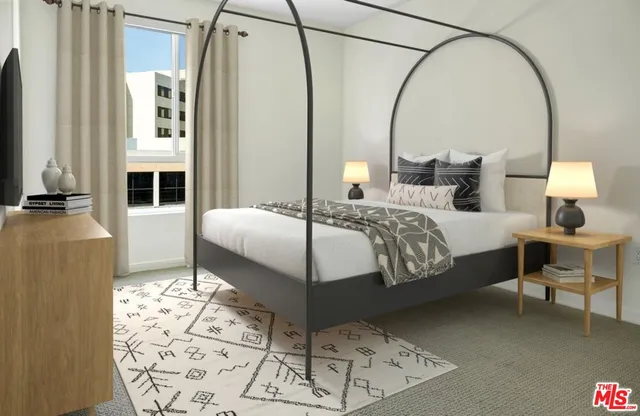 a living room with furniture a flat screen tv and kitchen view