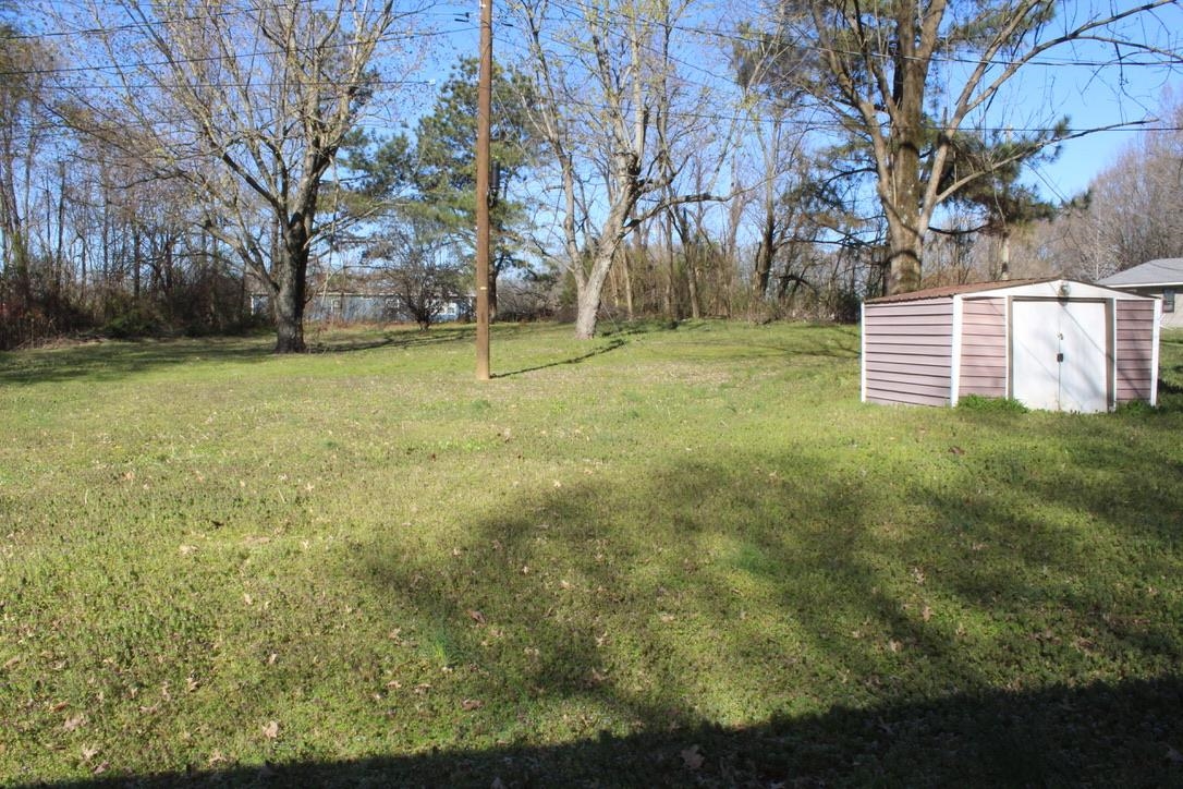 135 Ross Road Ripley, TN 38063 - Photo 14 of 18 a backyard of a house with lots of green space