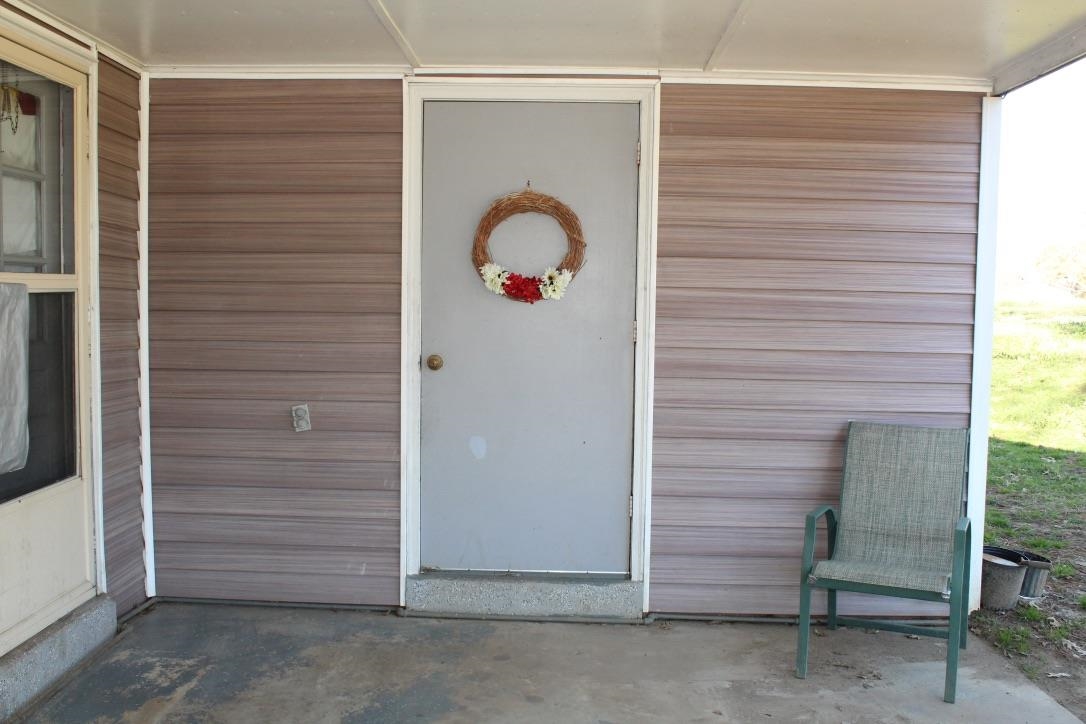 135 Ross Road Ripley, TN 38063 - Photo 4 of 18 a view of a door and chair in the room