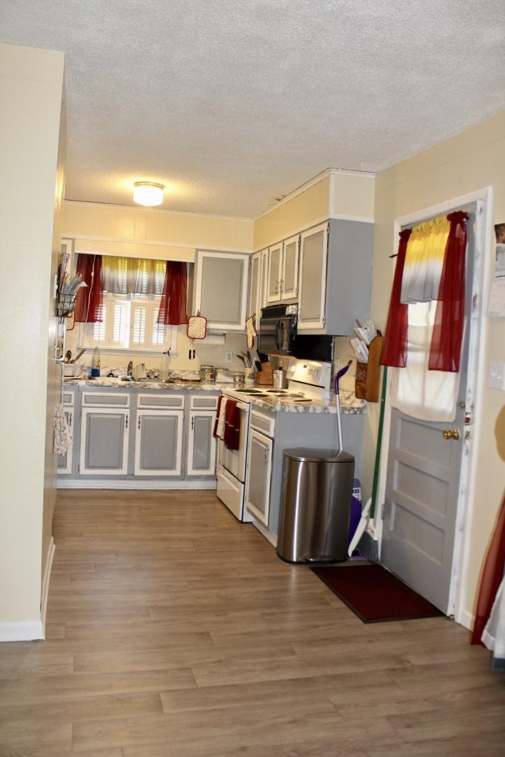 135 Ross Road Ripley, TN 38063 - Photo 5 of 18 a kitchen with stainless steel appliances granite countertop a stove top oven a sink and a refrigerator