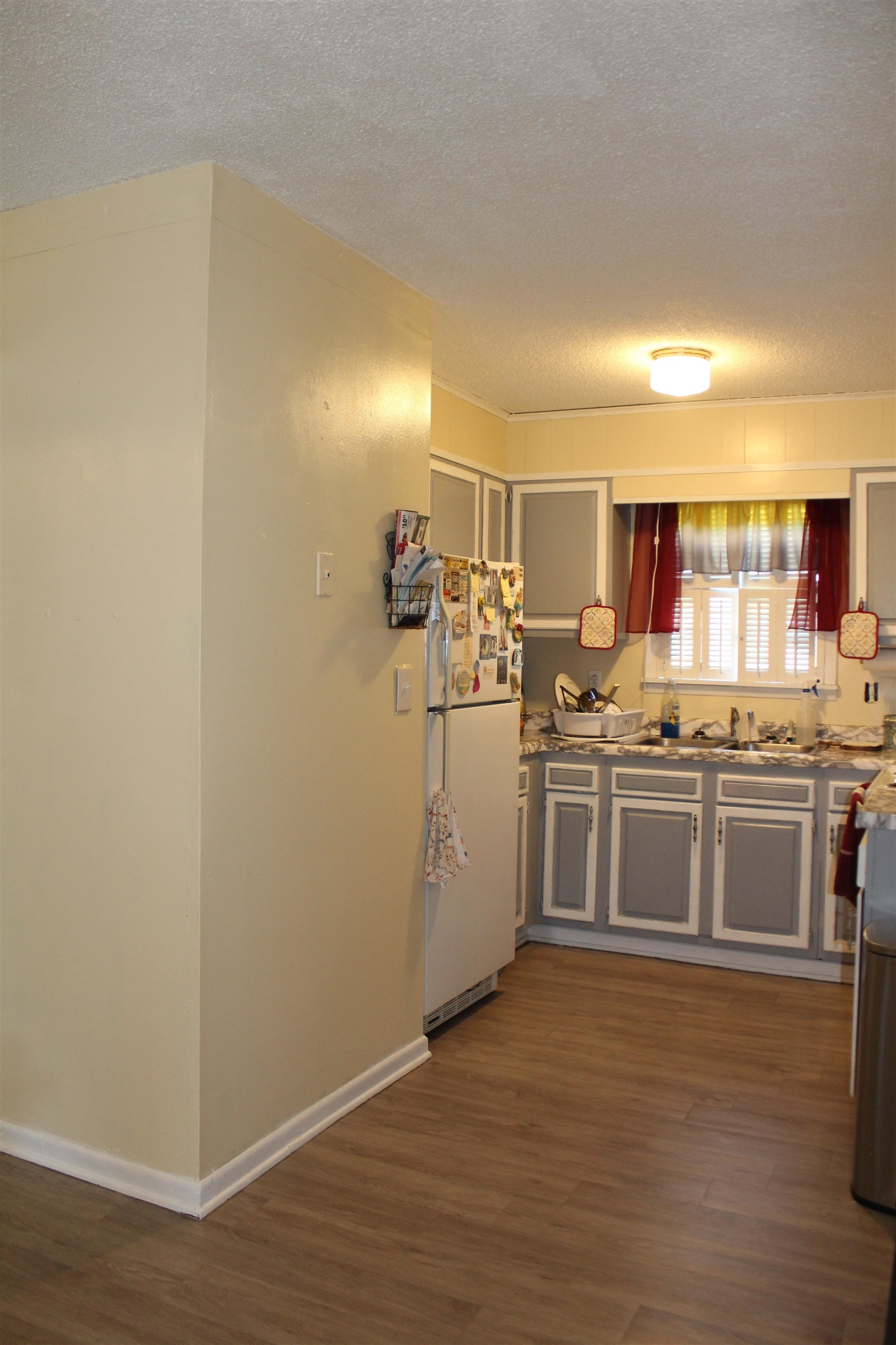 135 Ross Road Ripley, TN 38063 - Photo 6 of 18 a kitchen with a sink and wooden floor