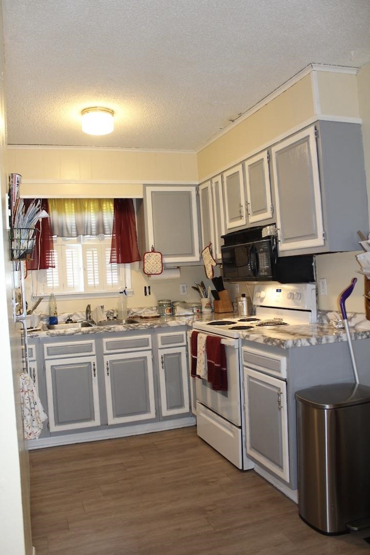 135 Ross Road Ripley, TN 38063 - Photo 7 of 18 a kitchen with stainless steel appliances granite countertop a stove and a sink