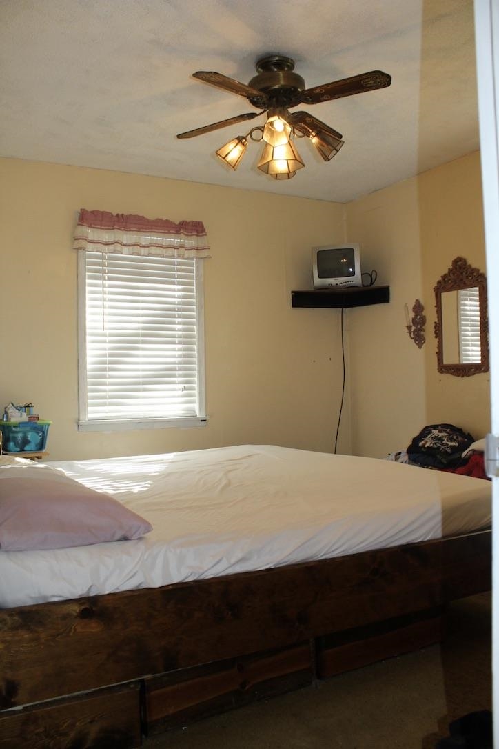 135 Ross Road Ripley, TN 38063 - Photo 10 of 18 a bedroom with a bed and a chandelier