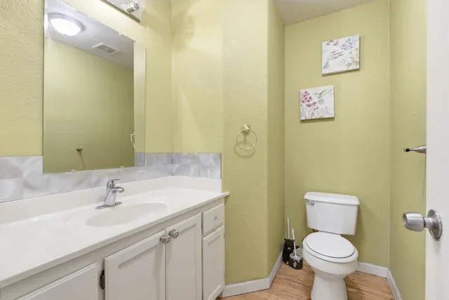 a kitchen with stainless steel appliances granite countertop wooden floor dining table and chairs