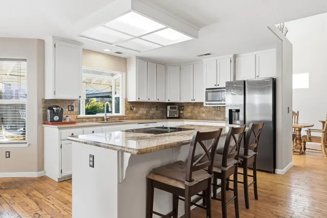 a living room with furniture a window and a flat screen tv