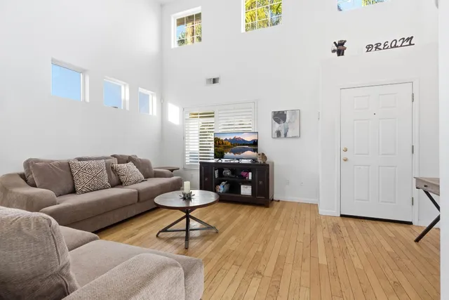 a living room with furniture and a dining table