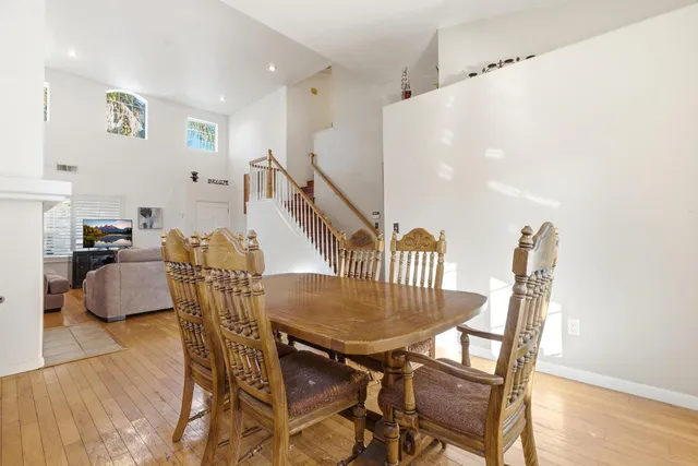 a view of staircase with wooden floor and white walls