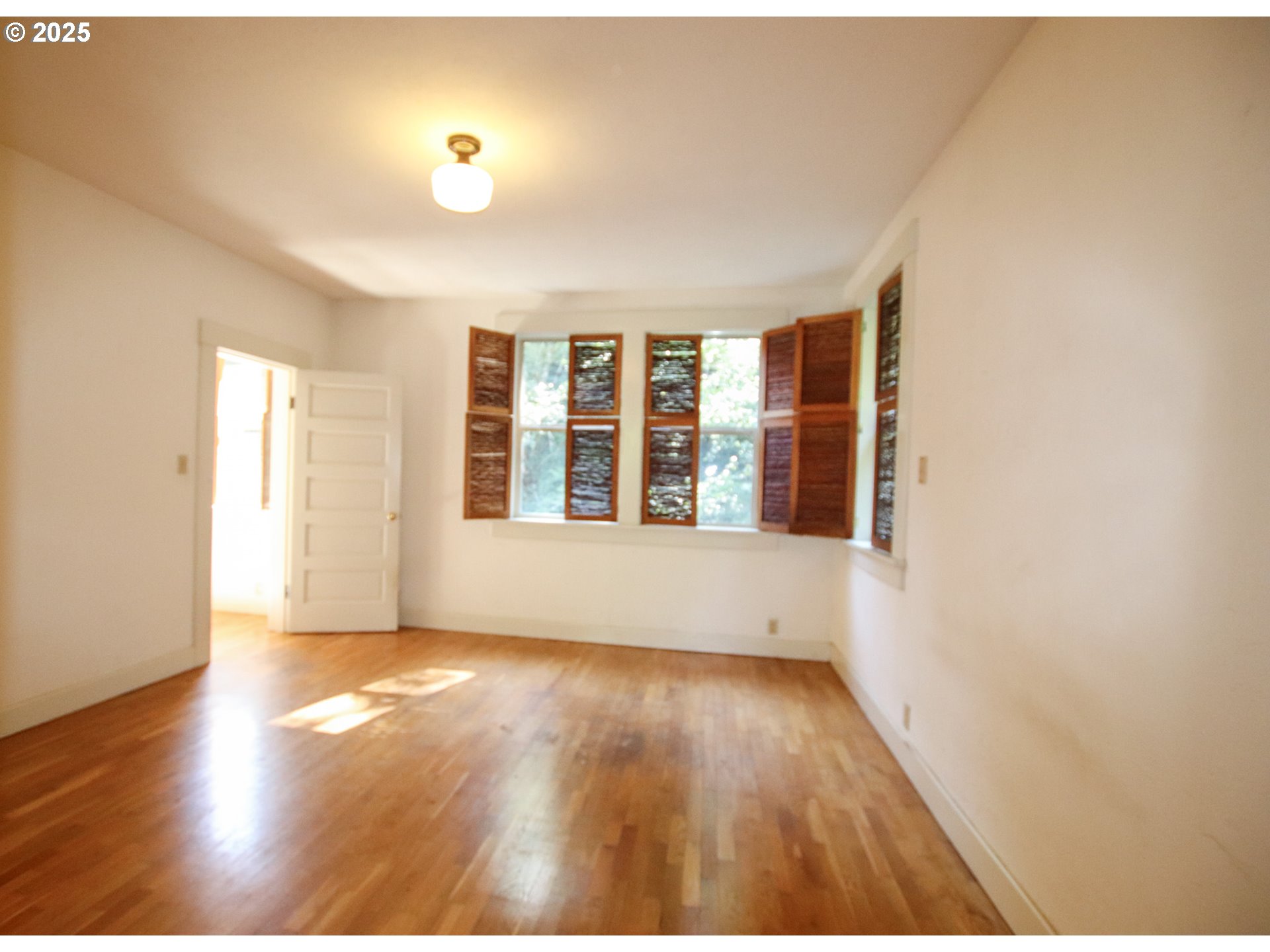 92976 Deadwood Creek Road Deadwood, OR 97430 - Photo 22 of 46 a view of an empty room with wooden floor and a window