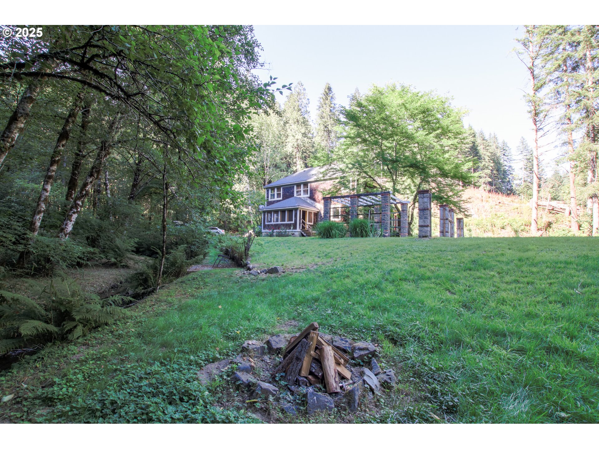92976 Deadwood Creek Road Deadwood, OR 97430 - Photo 5 of 46 a view of a house with a backyard