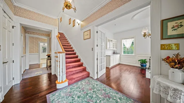 a view of a livingroom with furniture wooden floor and a chandelier