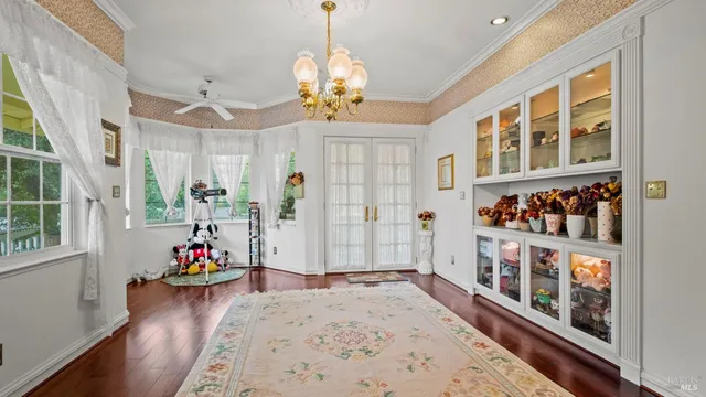 a living room with furniture flowerpot and wooden floor