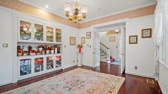 a kitchen with stainless steel appliances a stove a sink and white cabinets