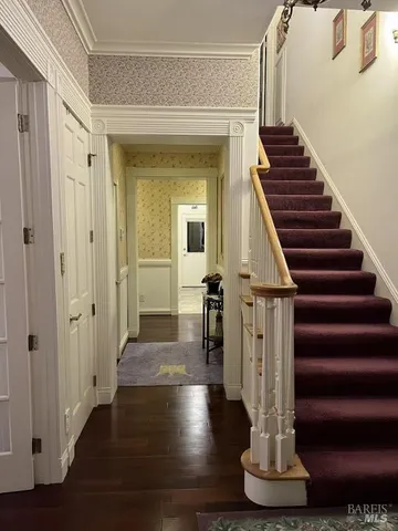 a living room with furniture a flat screen tv and gym equipment