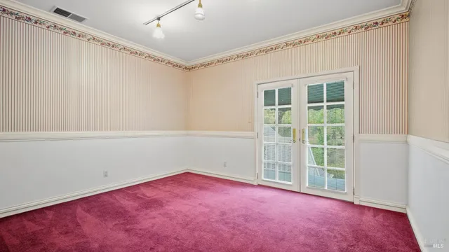 a kitchen with a checkered floor and white cabinets