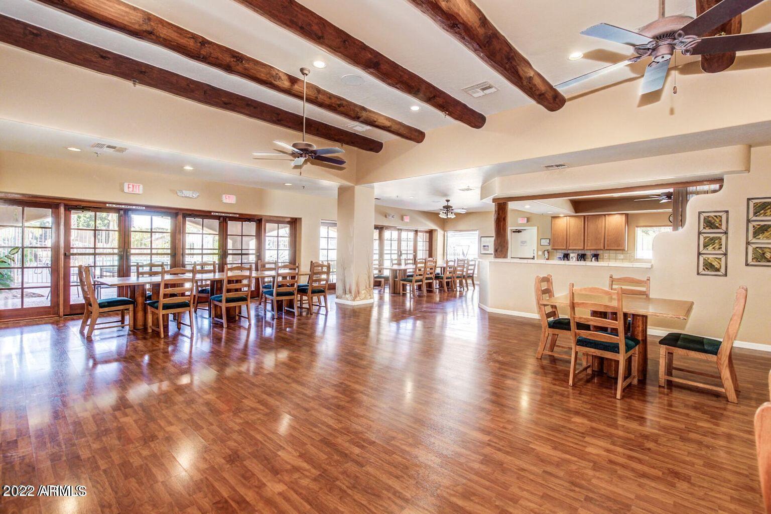 5830 East McKellips Road, Unit 76 Mesa, AZ 85215 - Photo 32 of 33 a view of a dining room with furniture and wooden floor