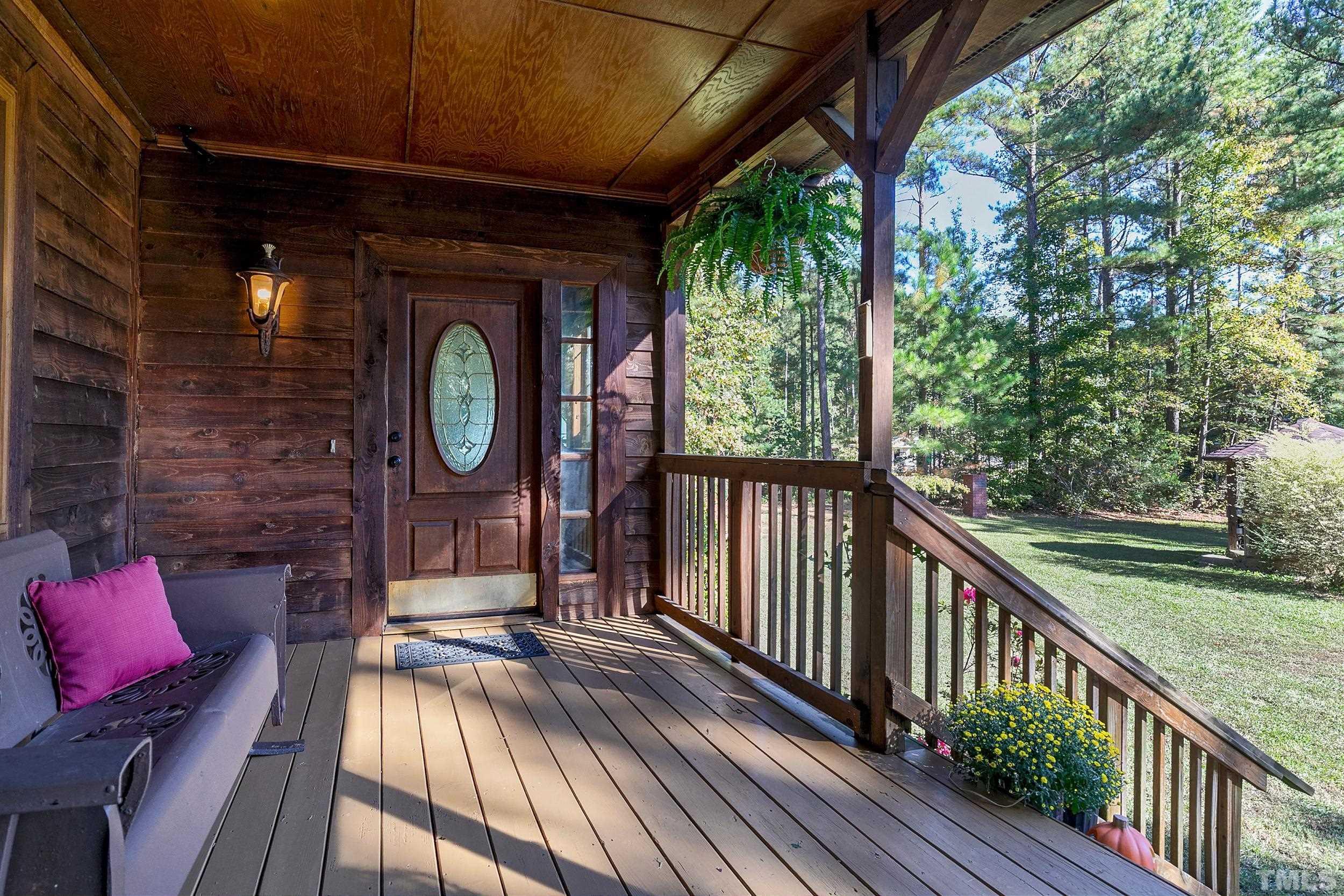 1300 Major Slade Road Wendell, NC 27591 - Photo 4 of 30 Large wrap around porch leads to screened porch and deck. Enjoy meals, beverages and entertaining from this large covered wrap porch as you look out on nature!