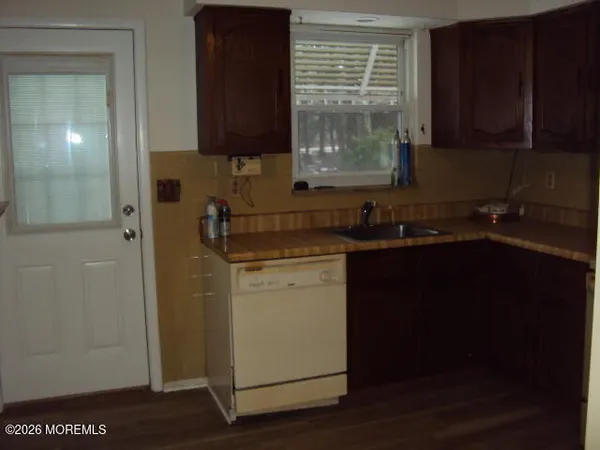 a kitchen with a sink a stove and cabinets