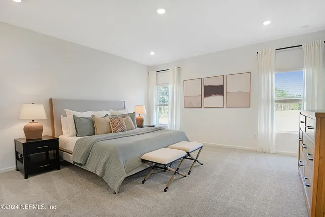 a spacious bedroom with a bed and a couch