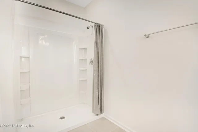 a bathroom with a glass shower door