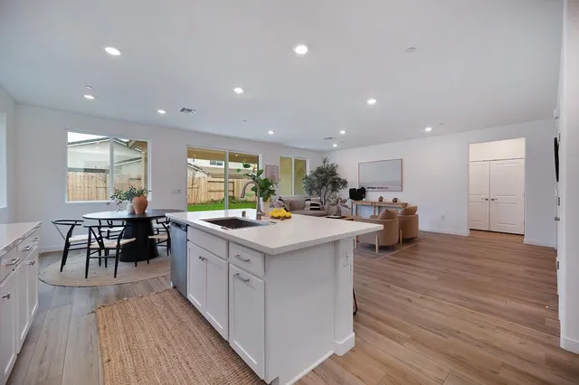 a kitchen with kitchen island a white counter top space and cabinets