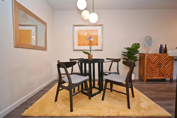 a view of a dining room with furniture wooden floor and a chandelier