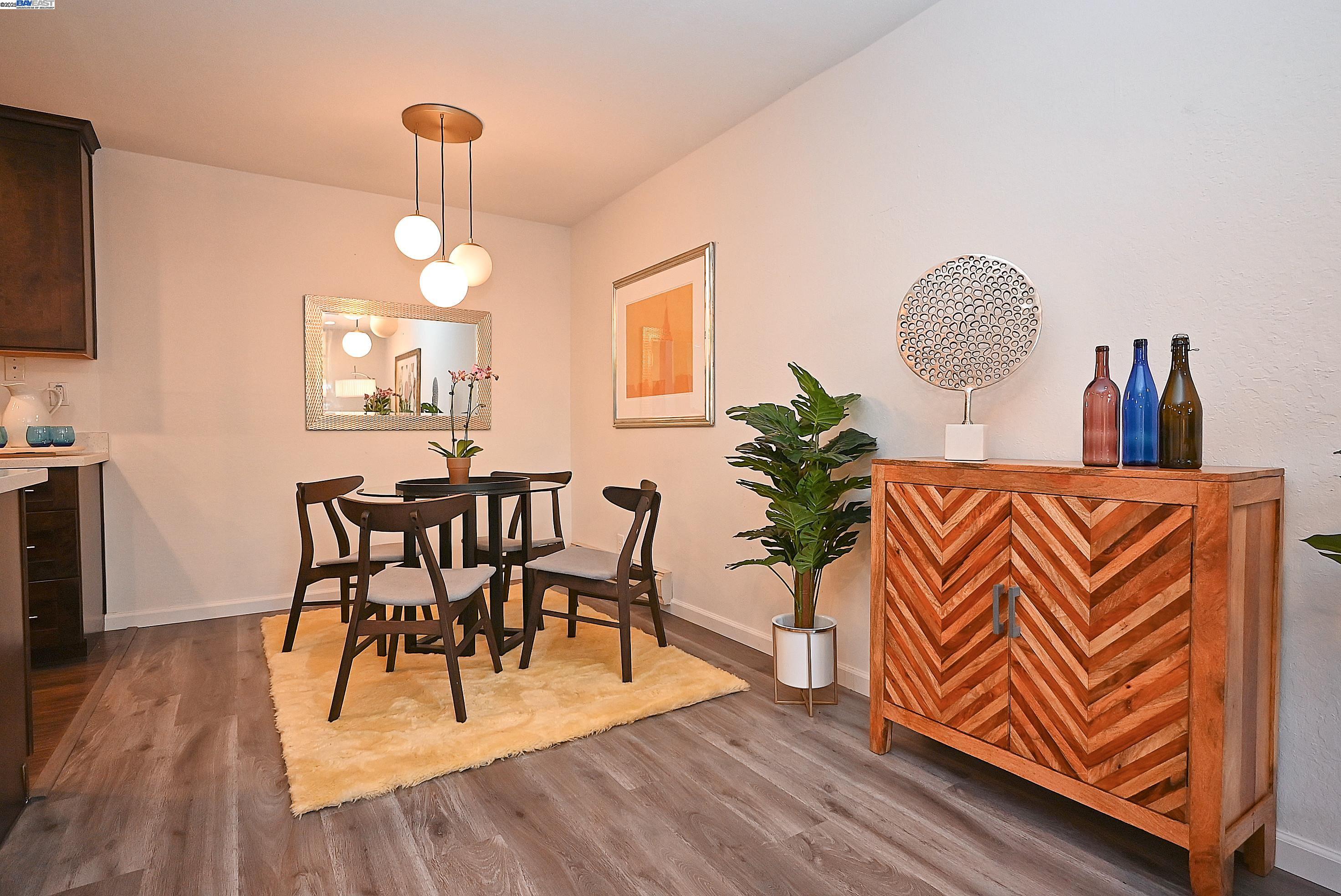 1333 Webster Street, Unit A107 Alameda, CA 94501 - Photo 13 of 27 a view of a dining room with furniture wooden floor and chandelier