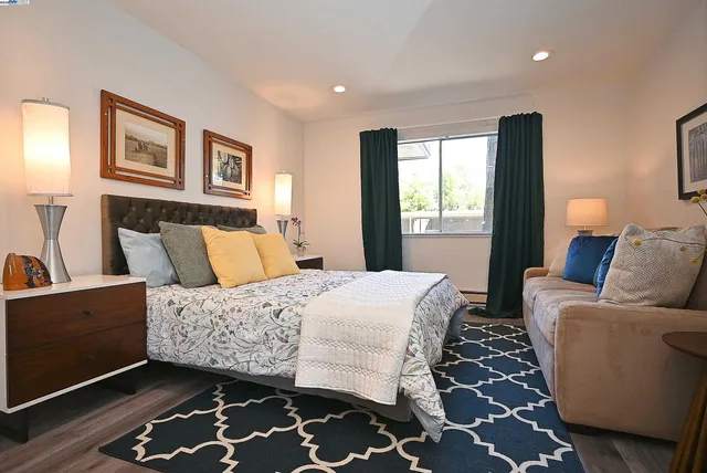 a bedroom with a bed and wooden floor