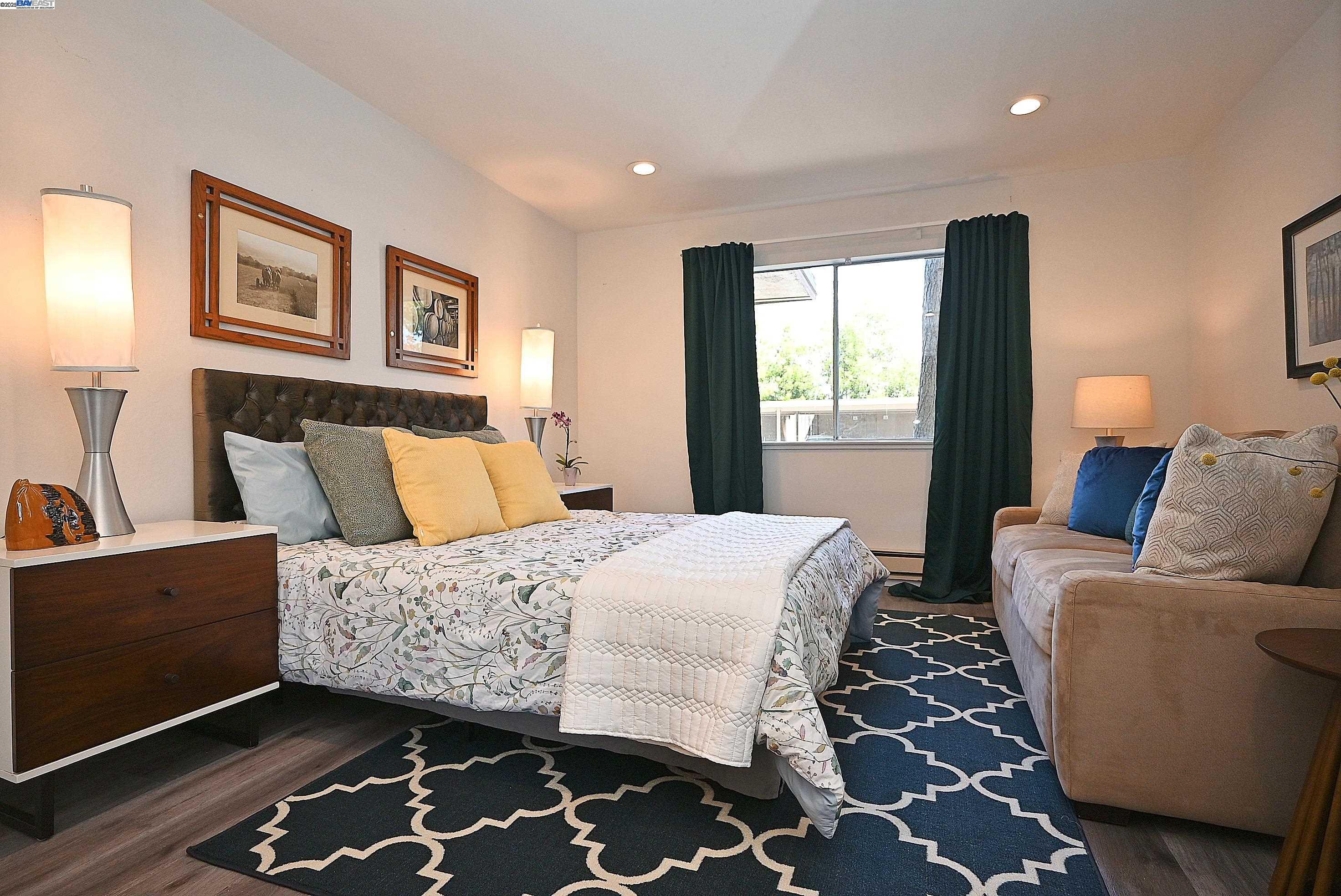 1333 Webster Street, Unit A107 Alameda, CA 94501 - Photo 15 of 27 a bedroom with a bed and wooden floor