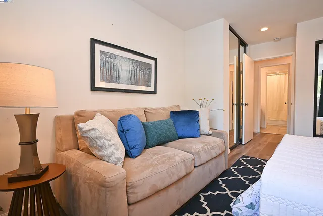 a living room with furniture and a lamp