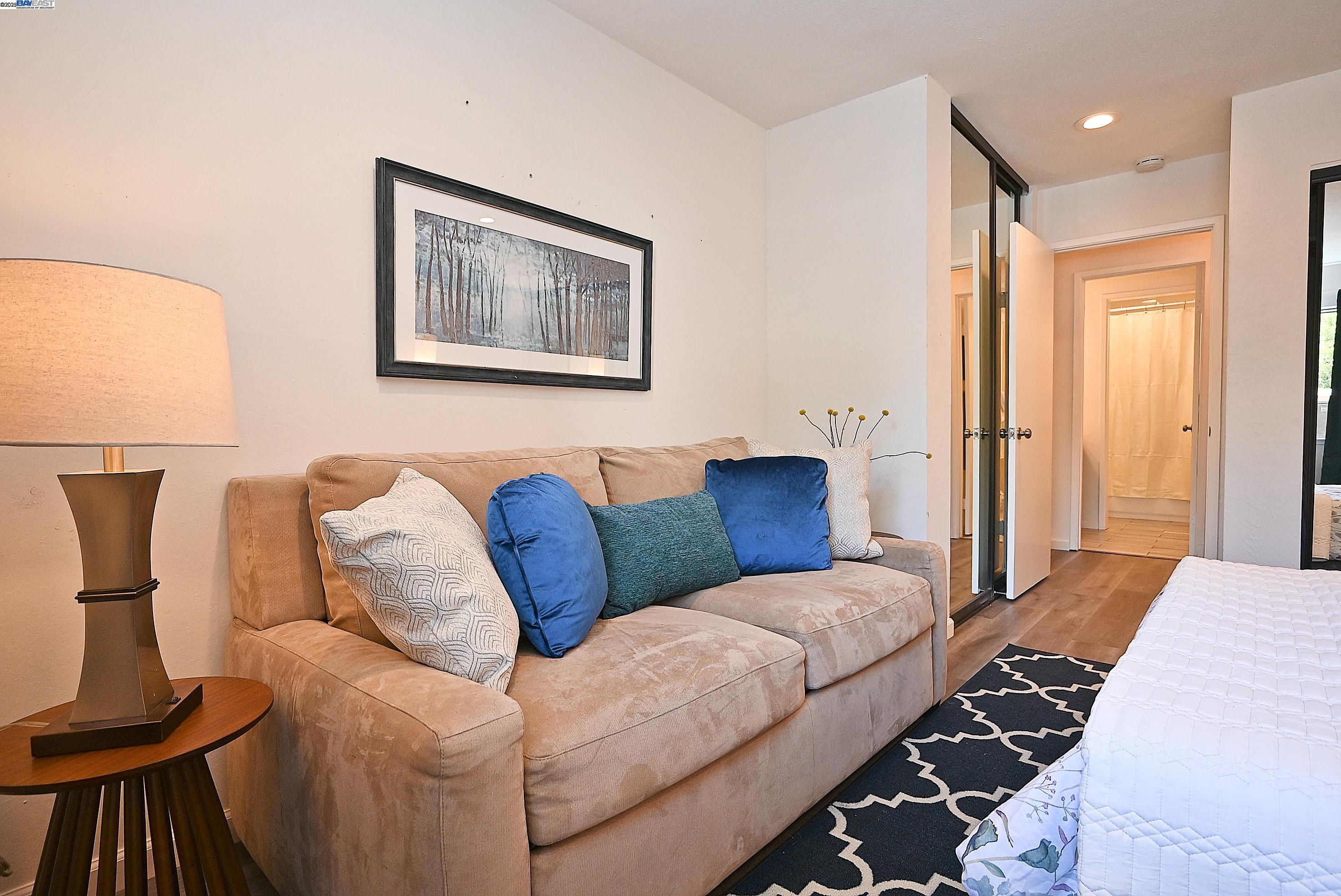1333 Webster Street, Unit A107 Alameda, CA 94501 - Photo 16 of 27 a living room with furniture and a lamp