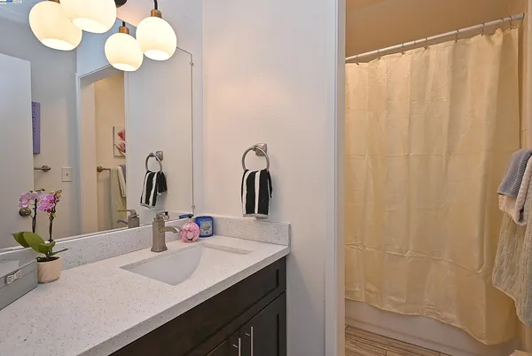 a bathroom with a sink vanity and a mirror