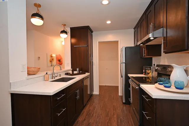 a kitchen with a sink stove and refrigerator