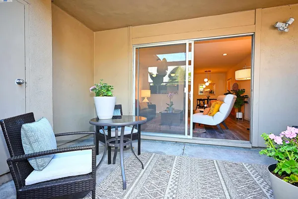 a view of a dining room with furniture and a potted plant