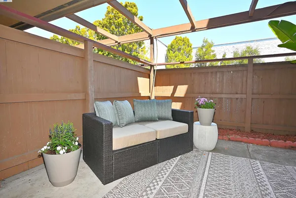 a outdoor living room with furniture and a potted plant