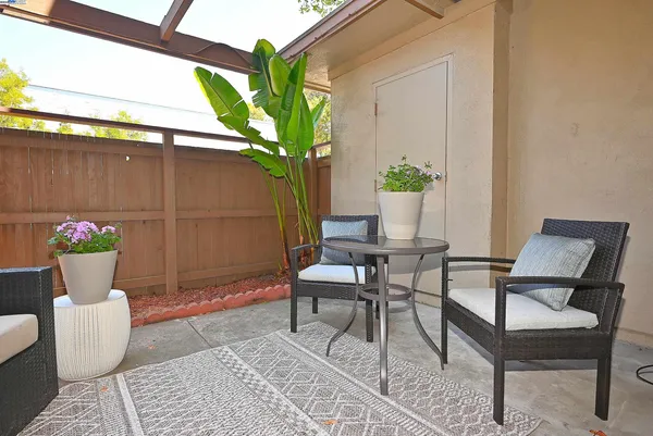a view of a chairs and table in a patio