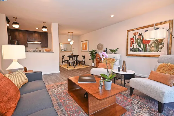 a living room with furniture and kitchen view