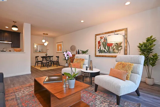 a living room with furniture and a painting on the wall